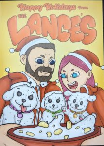 A drawn representation of "The Lances" breakfast cereal with Jer, Ger, and all three dogs in front of a bowl of cereal. The text reads "Happy Holidays from The Lance's"